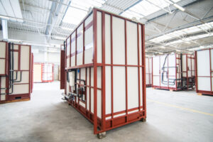 Completed prefabricated bathroom pod with white cladding on a steel frame in the Domczar hall.
