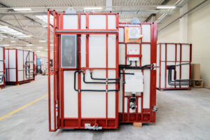 Prefabricated bathroom pod with water and drainage installation routed on the frame, in the production hall.
