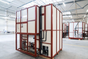 Row of completed prefabricated bathroom pods ready for dispatch in the Domczar hall.