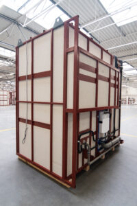 Prefabricated bathroom pod on a steel frame with plumbing, in the Domczar hall.